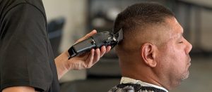 Student practices a high fade in the salon