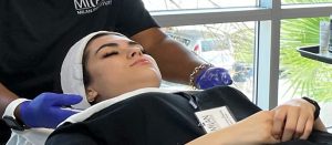 Two students practice esthetician skills in a Milan lab