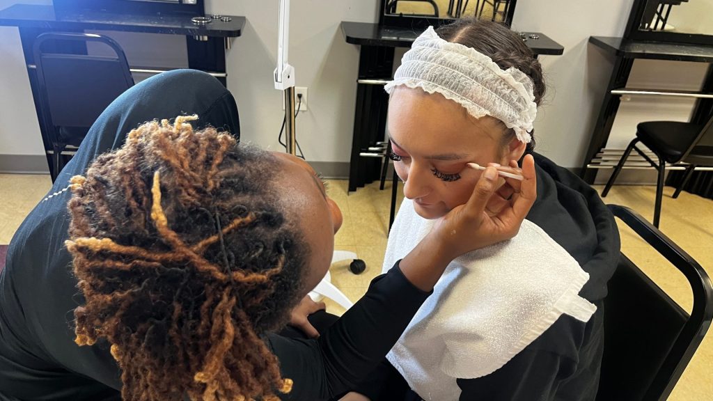 Esthetician students practice makeup on each other in San Antonio