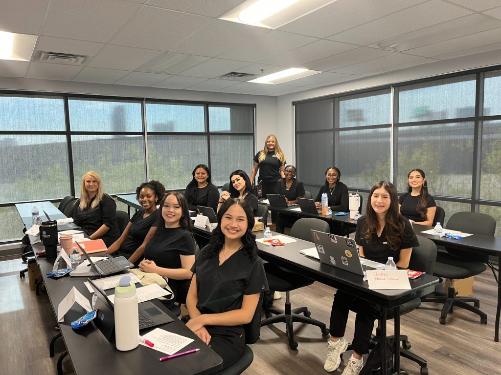 Nail Tech students pose in Nevada classroom lab at Milan Institute.