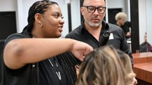 San Antonio Ingram, Milan Institute instructor works with students on the salon floor