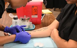 Visalia medical assistant students practice injections during class