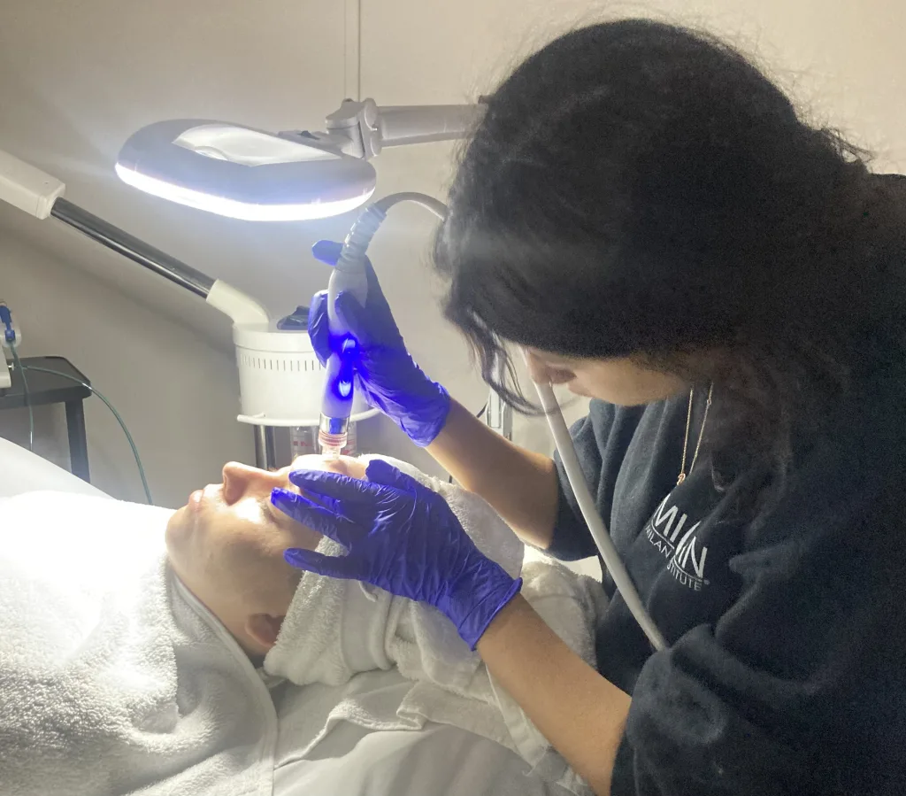 Esthetician student practices a HydraFacial treatment in Bakersfield, California