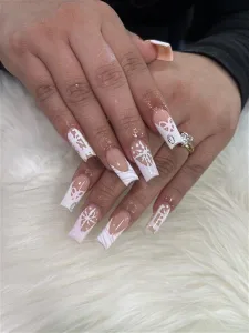 Holiday themed manicure with snowflakes and white tips