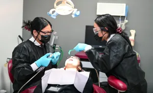 Dental students in Palm Desert perform a cleaning during class