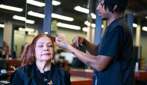 Cosmetology student gives hair cut in the salon