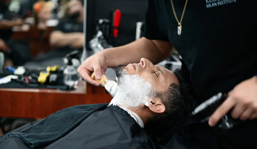 Student barber performs a face shave in Vacaville, California