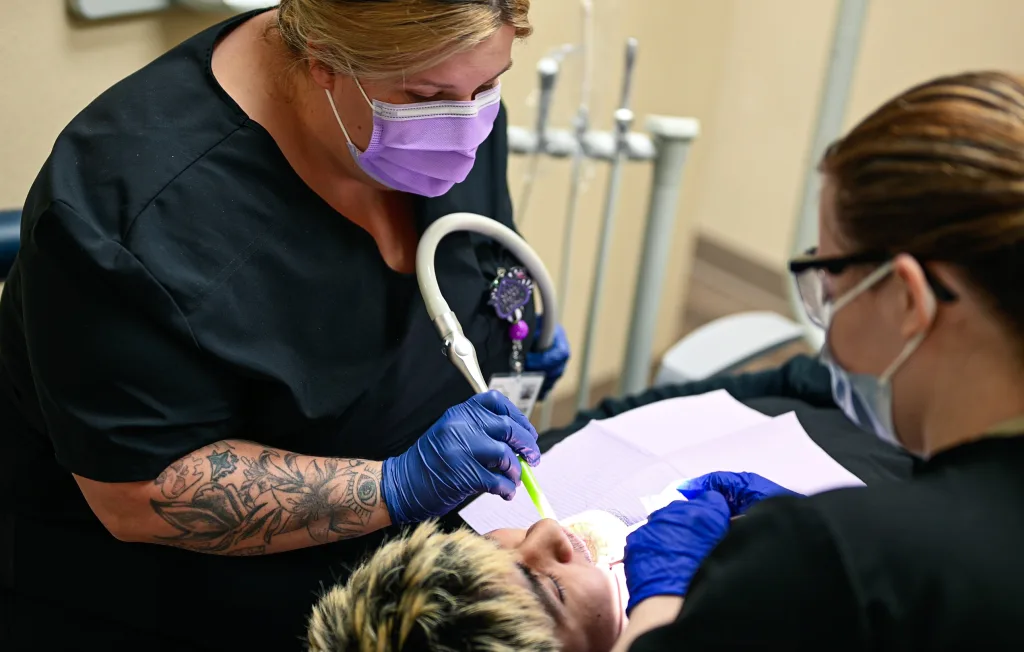 Dental cleaning performed by two students