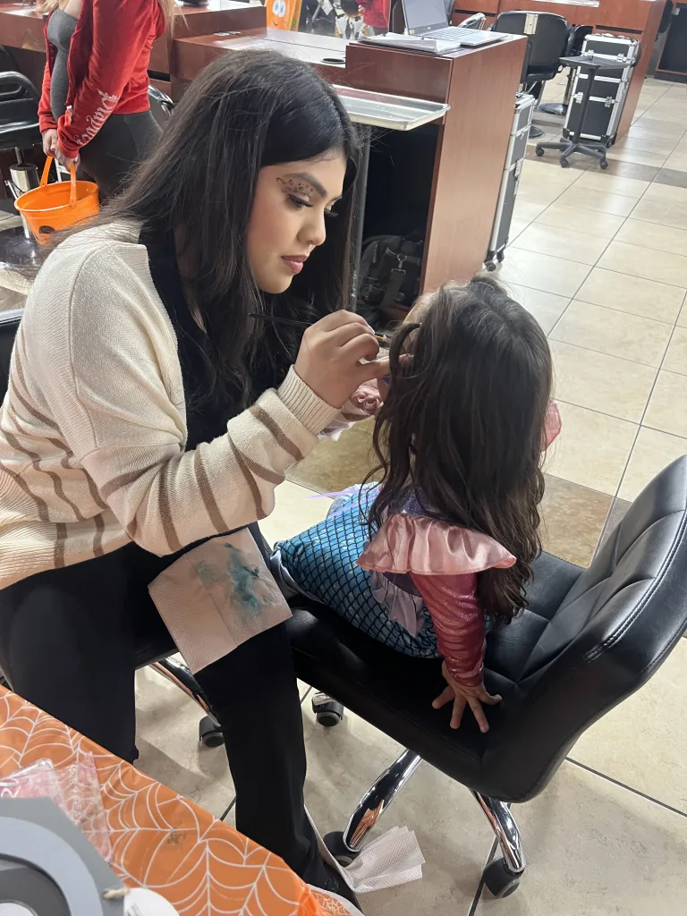 Milan students offered free face painting in Bakersfield for their Trunk or Treat event.